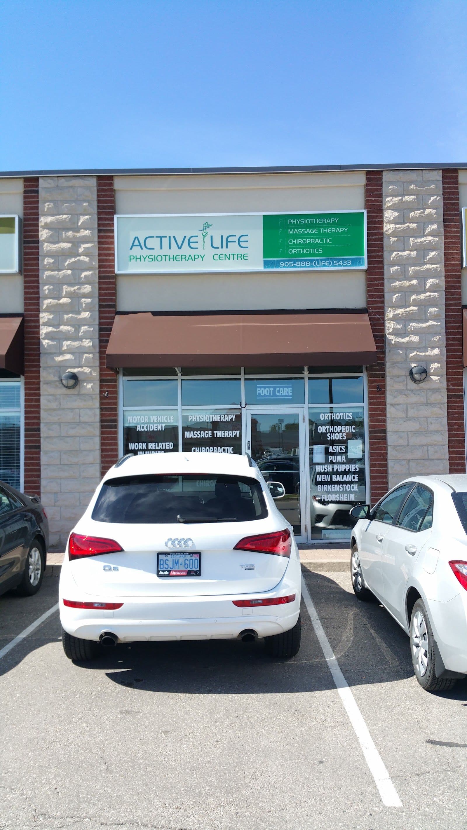A physiotherapy clinic team member reviews patient feedback and Google ratings at the front desk of Active Life Physiotherapy Centre