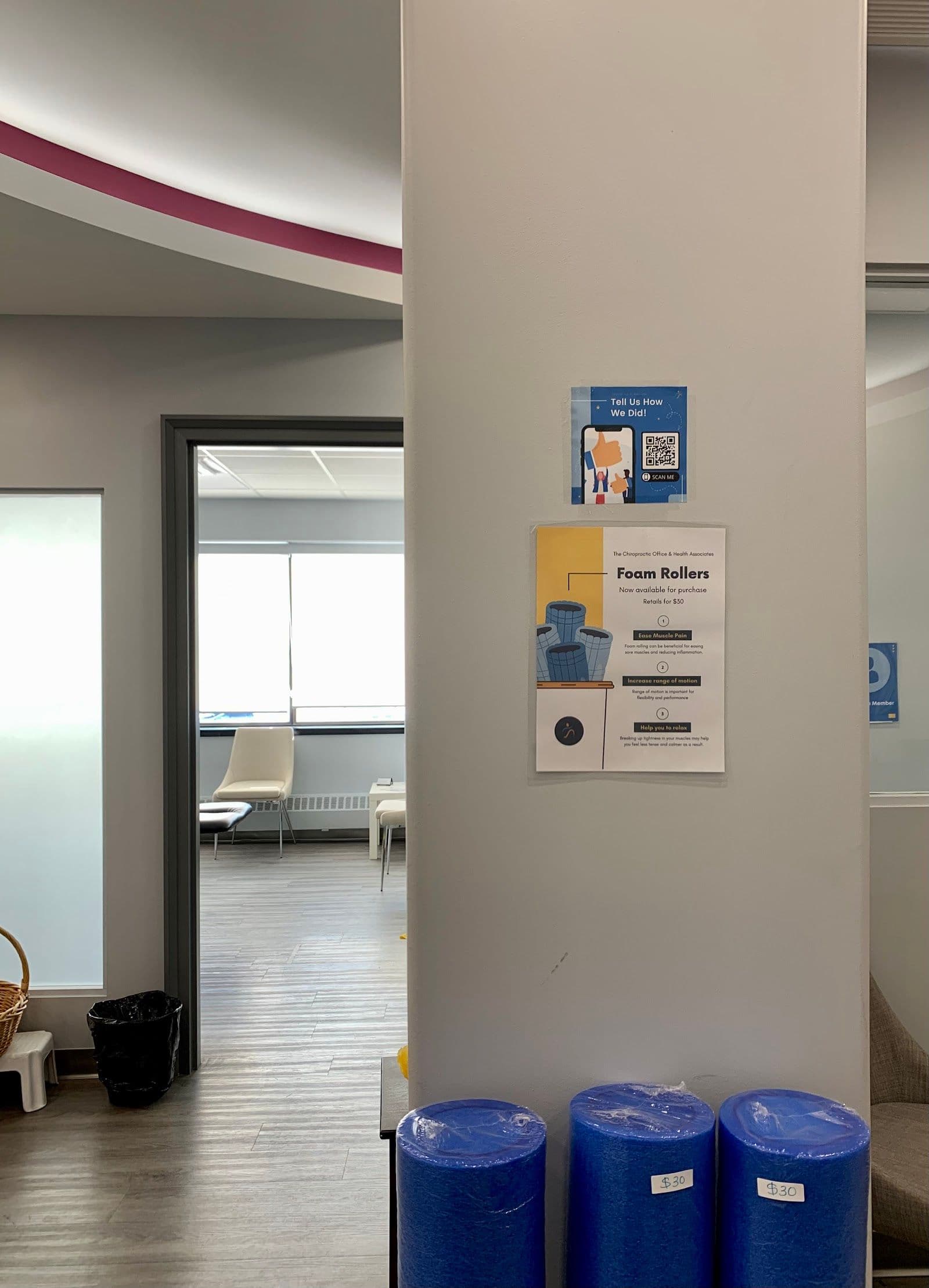 Chiropractic clinic front desk team reviewing patient feedback and Google reviews together on a tablet at the reception area