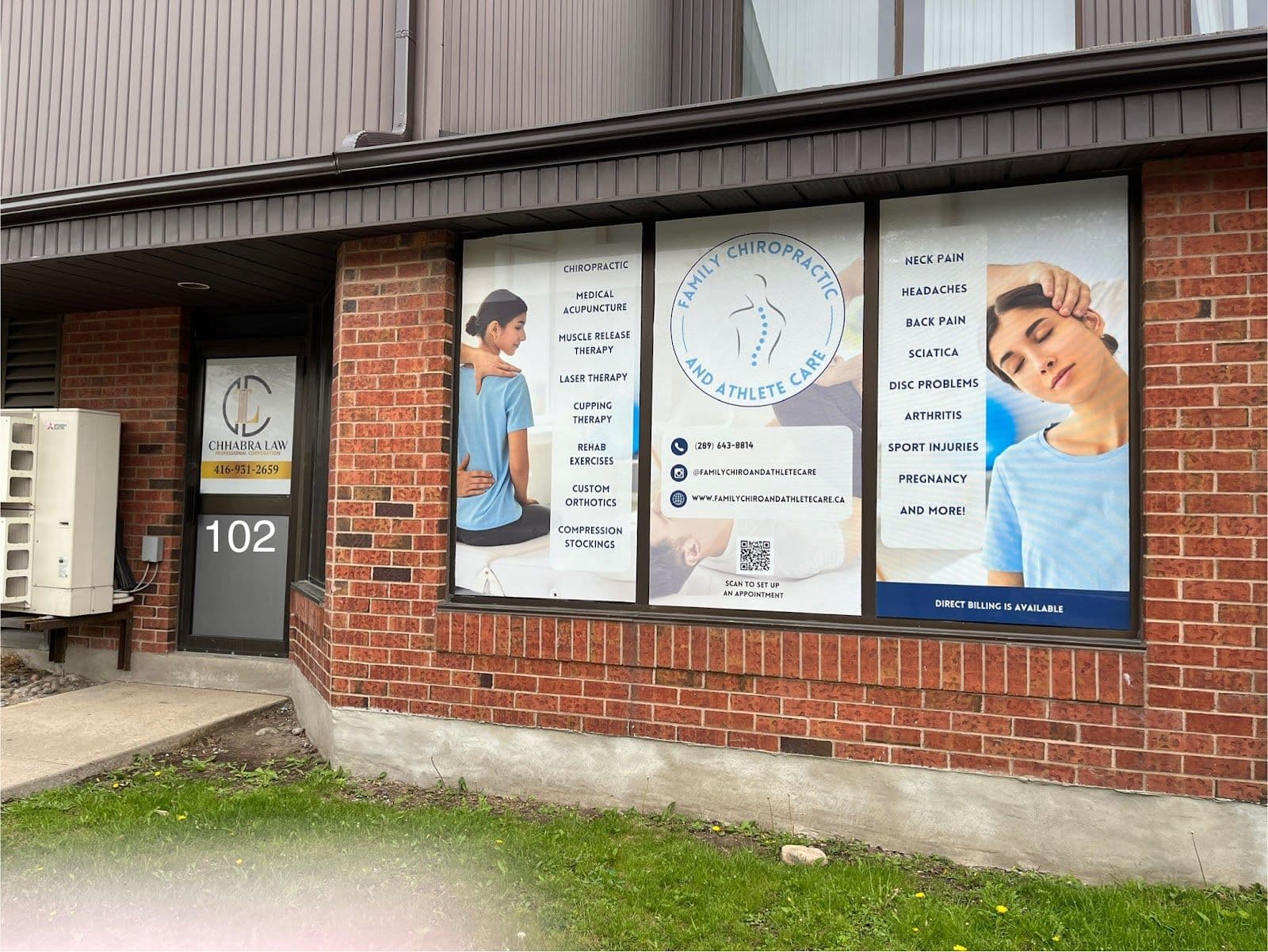 Chiropractic clinic front desk team reviewing patient feedback together on a tablet in a clean, welcoming treatment area
