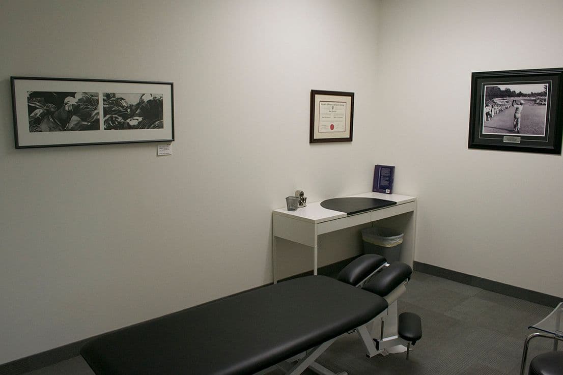 Clinic team reviewing patient feedback together at the front desk of Project Health & Performance in Mississauga