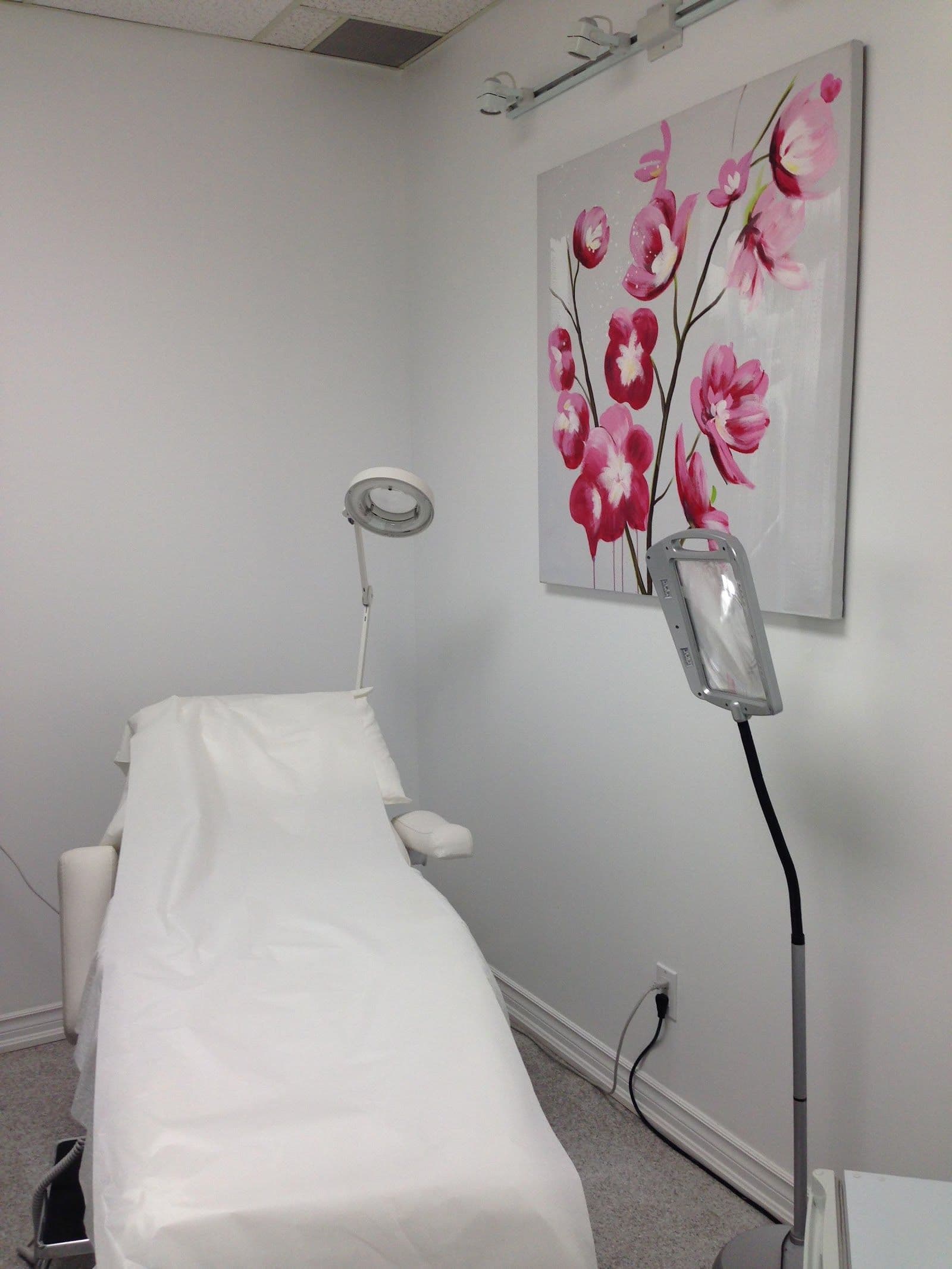 Clinic team reviewing patient feedback together at the front desk of a dermatology and laser centre
