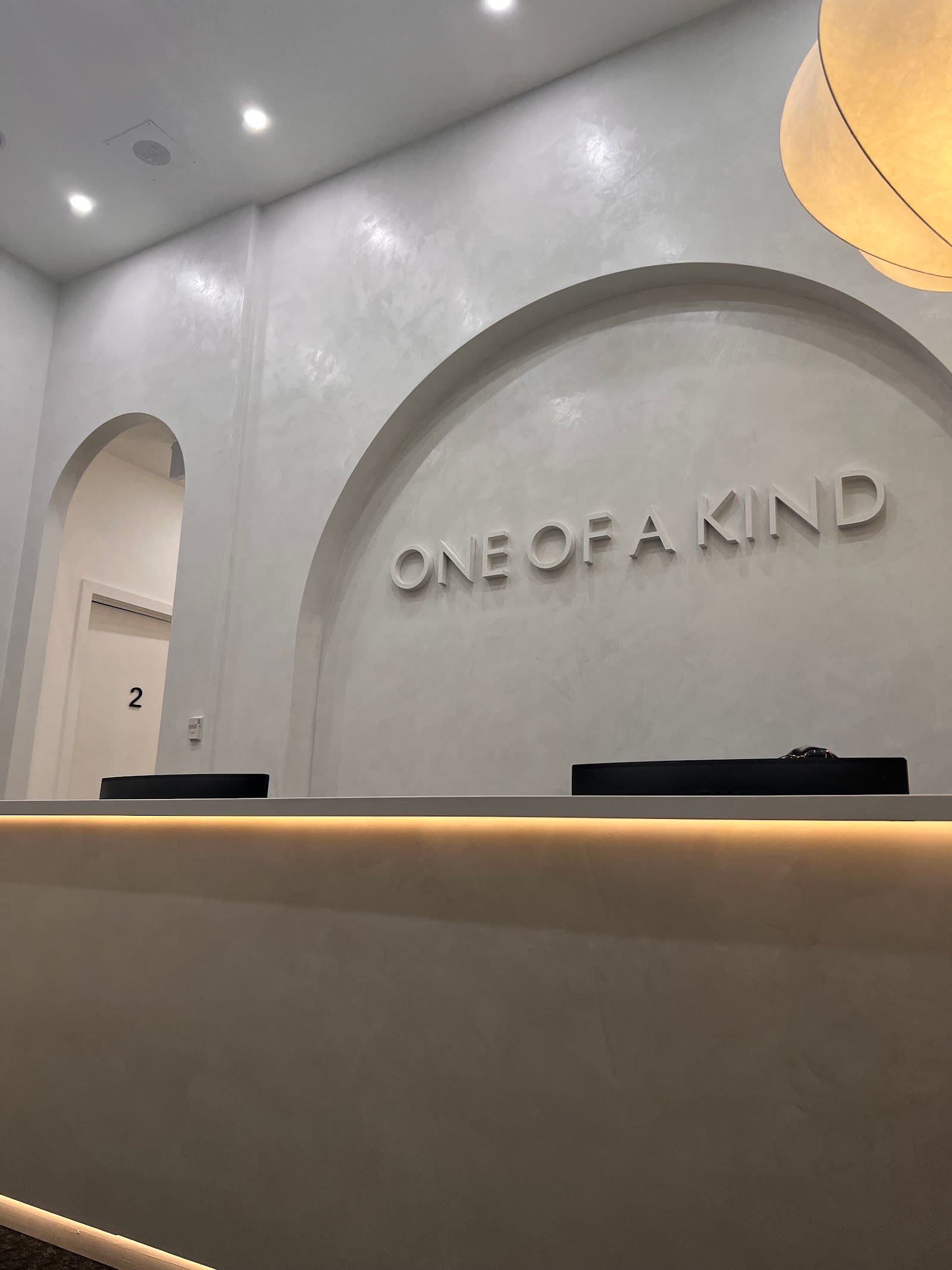 A clinic team at OAK Physio & Wellness reviewing patient feedback together at the front desk